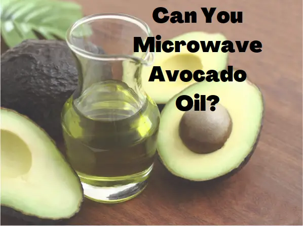 An avocado beside a glass jar of avocado oil