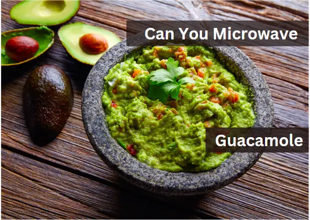 avocado halves on a wooden table beside a bowl of guacamole with the text" can you microwave guacamole"