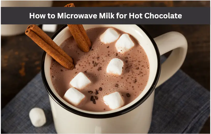 a white mug of hot chocolate, marshmallows, and cinnamon sticks